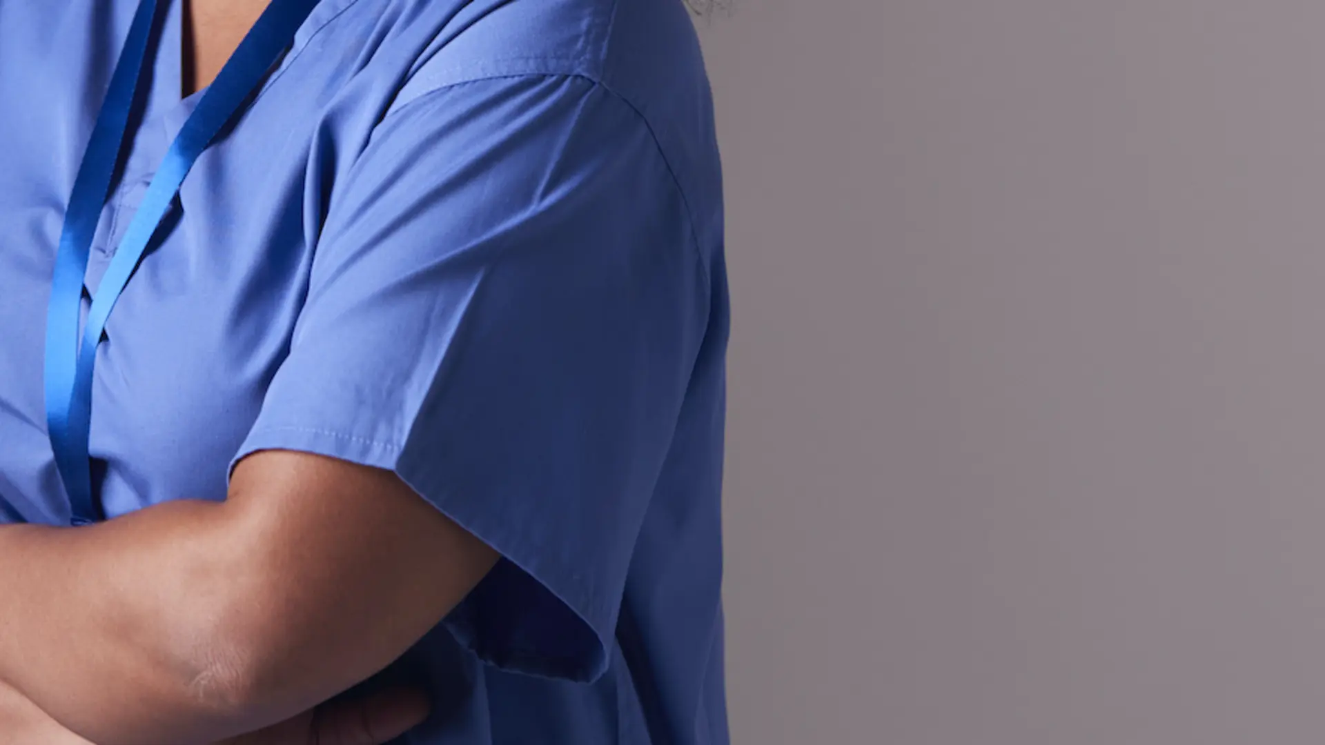 Medic standing with her arms folded