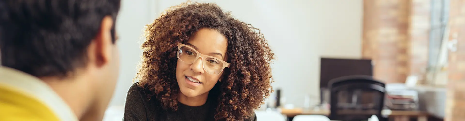 A Functional Assessor sitting at a desk and discussing