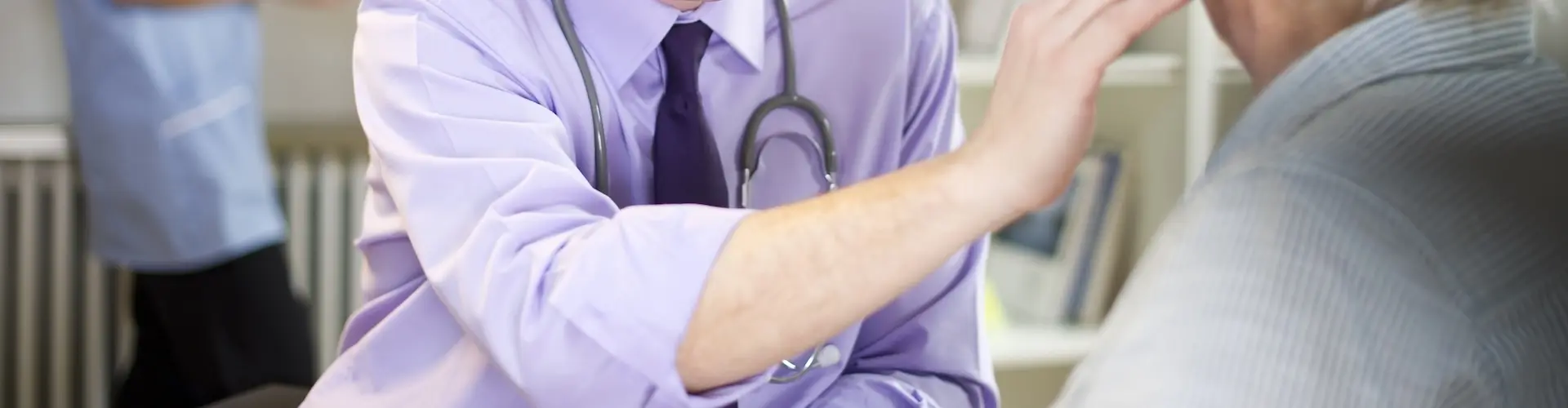 Doctor treating patient in a hospital ward