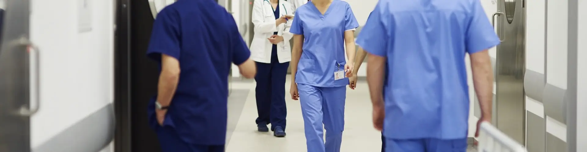 Healthcare professionals in a hospital corridor