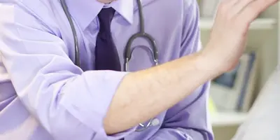 Doctor treating patient in a hospital ward
