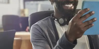Student in classroom looking at a tablet