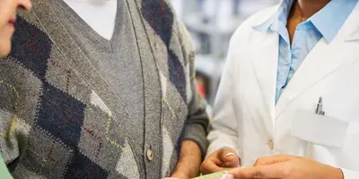 Pharmacist advising a customer