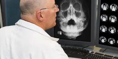 Radiographer examining images