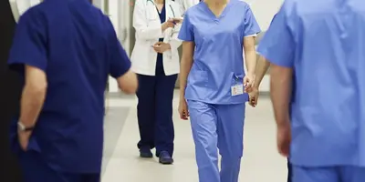 Healthcare professionals in a hospital corridor